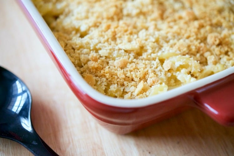 A close up of Bacon Cheddar Macaroni and Cheese in a red baking dish. 