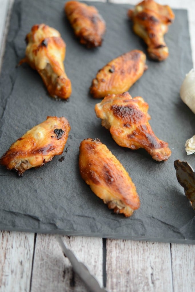 Baked Honey Garlic Chicken Wings on a piece of slate. 