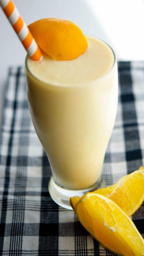 Orange creamsicle smoothie in a clear glass.