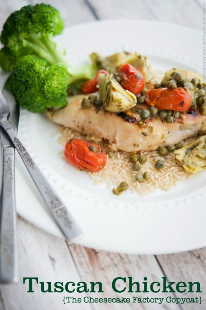 A plate of food with chicken, broccoli, tomatoes and capers.