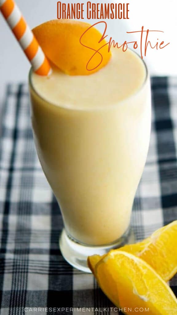 a glass filled with an orange smoothie