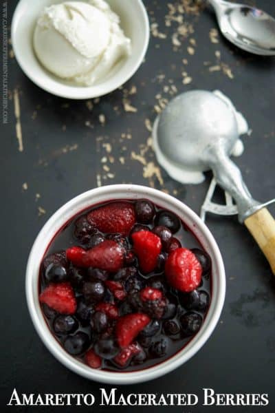 A bowl of berries with an ice cream scoop.
