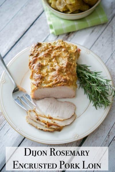 Dijon Rosemary Encrusted Pork Loin  sliced on a platter.