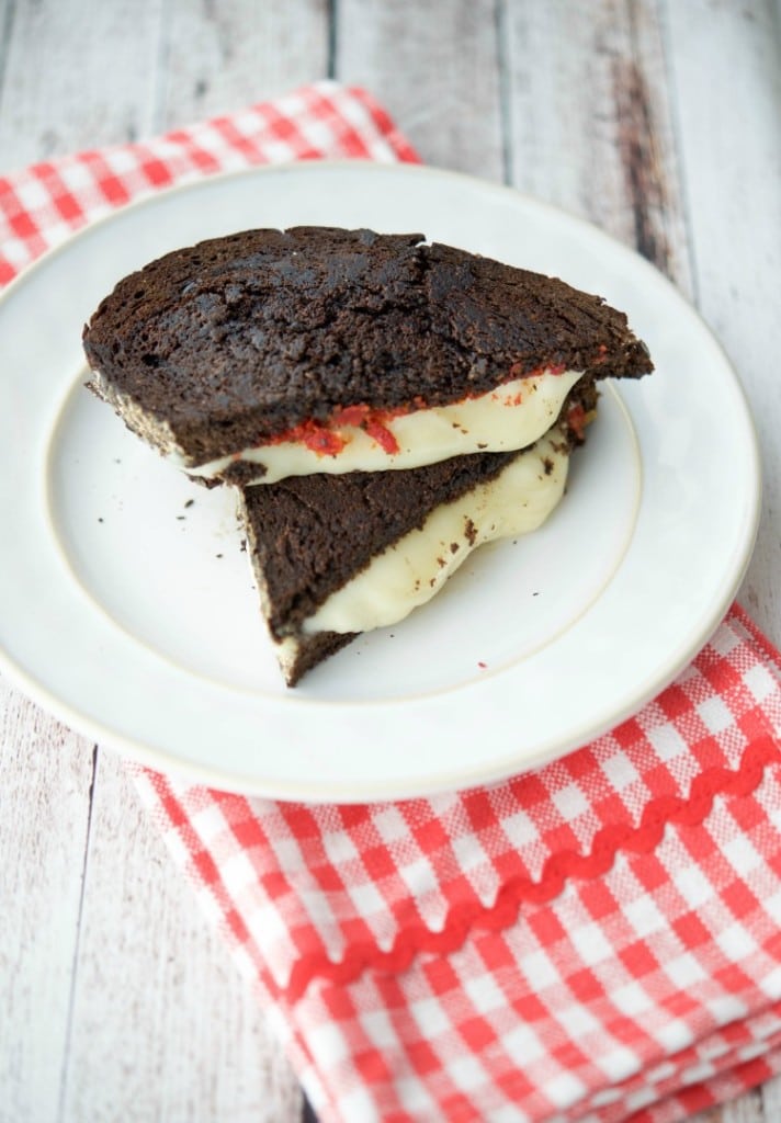 A closeup of a grilled provolone cheese sandwich on a plate. 