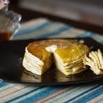 A stack of pancakes on a plate.