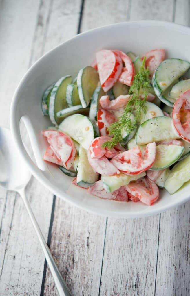 Ranch Tomato Cucumber Salad in a bowl on a wooden table