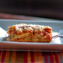 A close up of a plate of food, with Parmesan and Zucchini