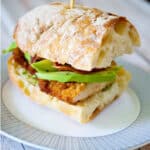This Chicken Cutlet Sandwich with crispy bacon, ripe avocados and pesto on Ciabatta bread is so hearty, it's perfect for lunch or dinner.