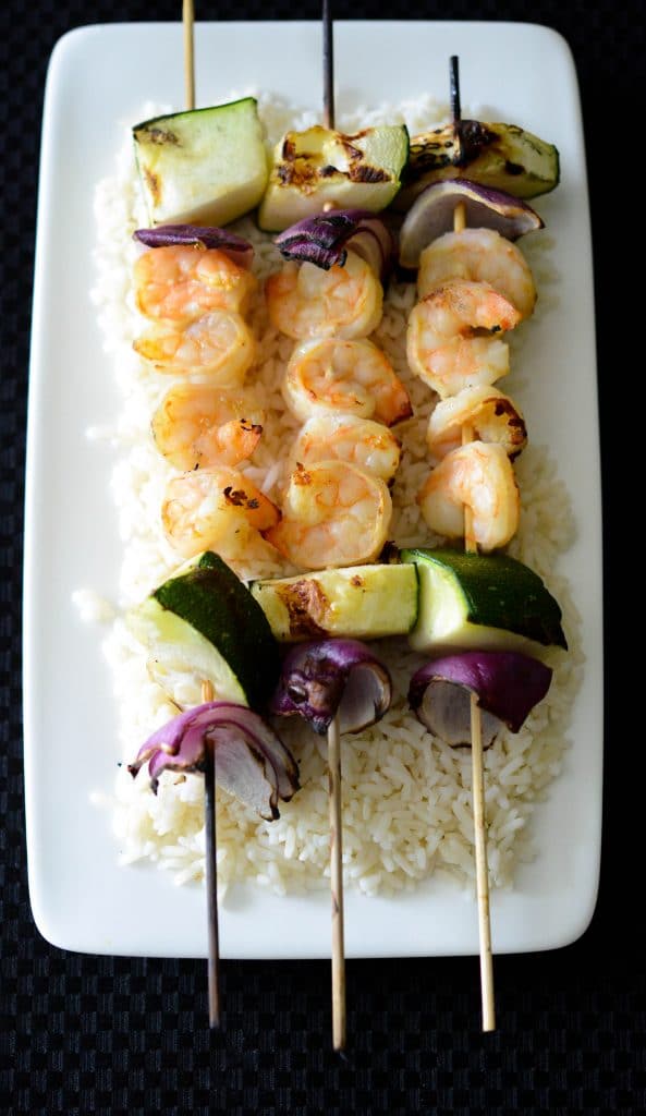 Dijon Maple Shrimp on wooden skewers with vegetables. 