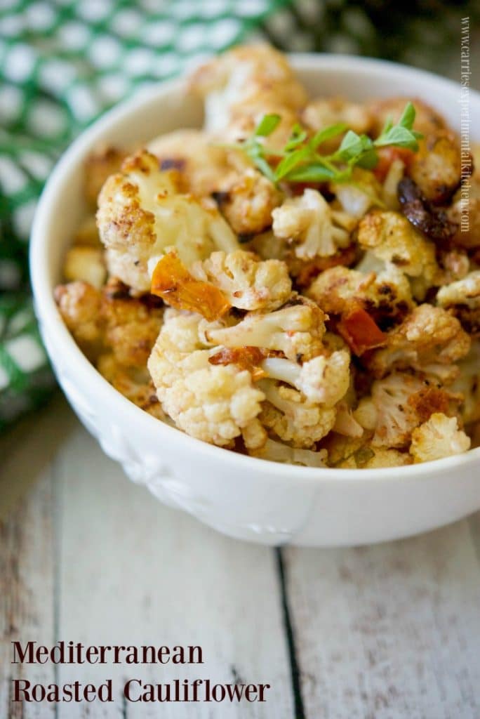 Mediterranean roasted cauliflower in a white bowl.