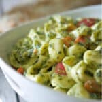 Cheese filled tortellini pasta tossed in a creamy spinach and tomato sauce is a deliciously quick weeknight meal.