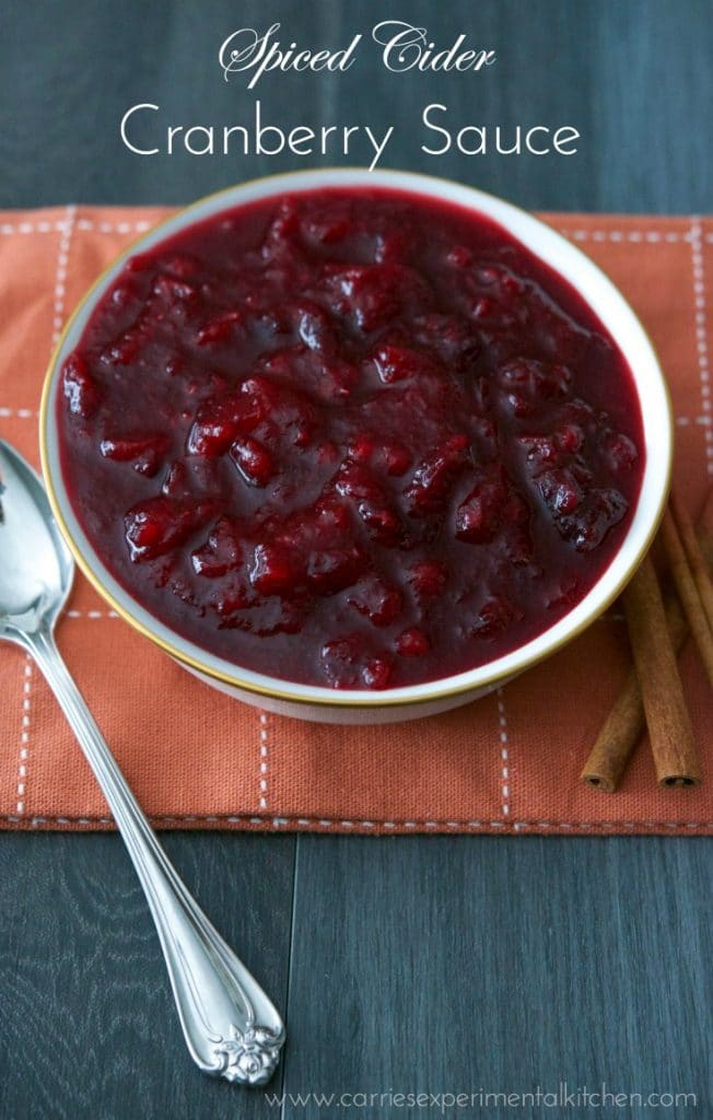 Spiced Cider Cranberry Sauce in a bowl on a rust colored napkin. 