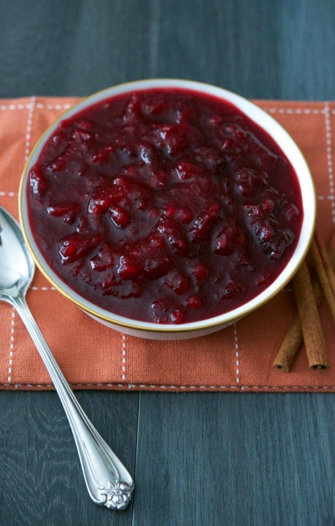 Spiced Cider Cranberry Sauce made with fresh whole cranberries slowly simmered in apple cider, sugar and pumpkin pie spice will make a tasty addition to your Thanksgiving table. 
