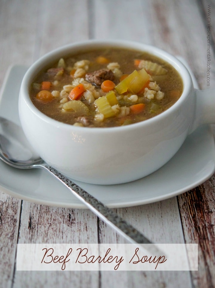 A bowl of soup on a table, with Beef barley soup