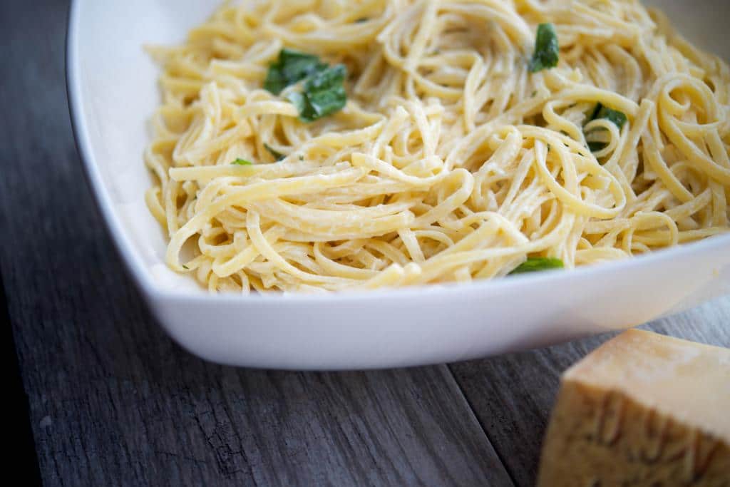 A bowl of linguine with limoncello asiago cream sauce. 