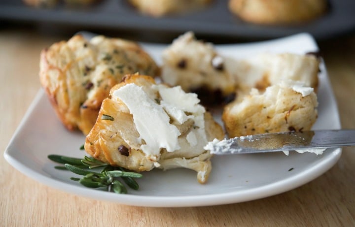 Savory Mediterranean Monkey Bread Rolls with butter on a plate. 