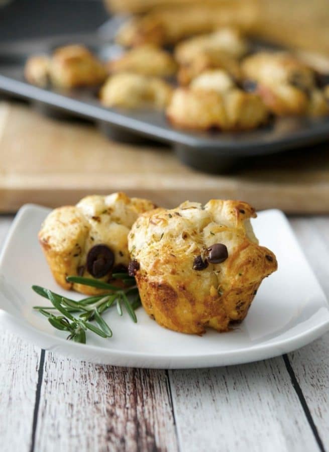These Savory Mediterranean Monkey Bread Rolls made with flaky biscuits, fresh rosemary, sun dried tomatoes, Kalamata olives and a variety of cheeses are the perfect accompaniment to any meal.