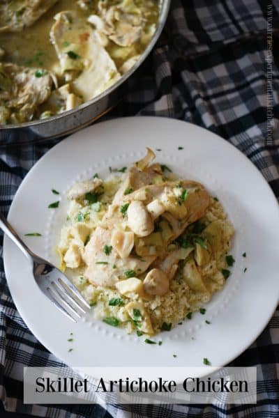Chicken on a plate with artichoke hearts.