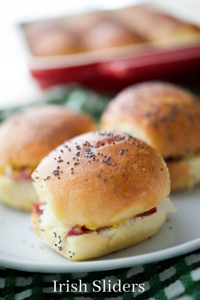 A close up of Irish Sliders on potato slider rolls on a plate. 