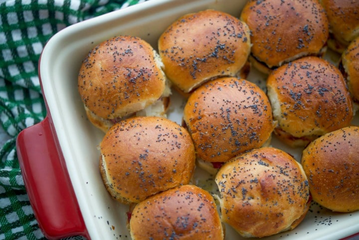 Irish Sliders on potato slider rolls in a baking dish. 