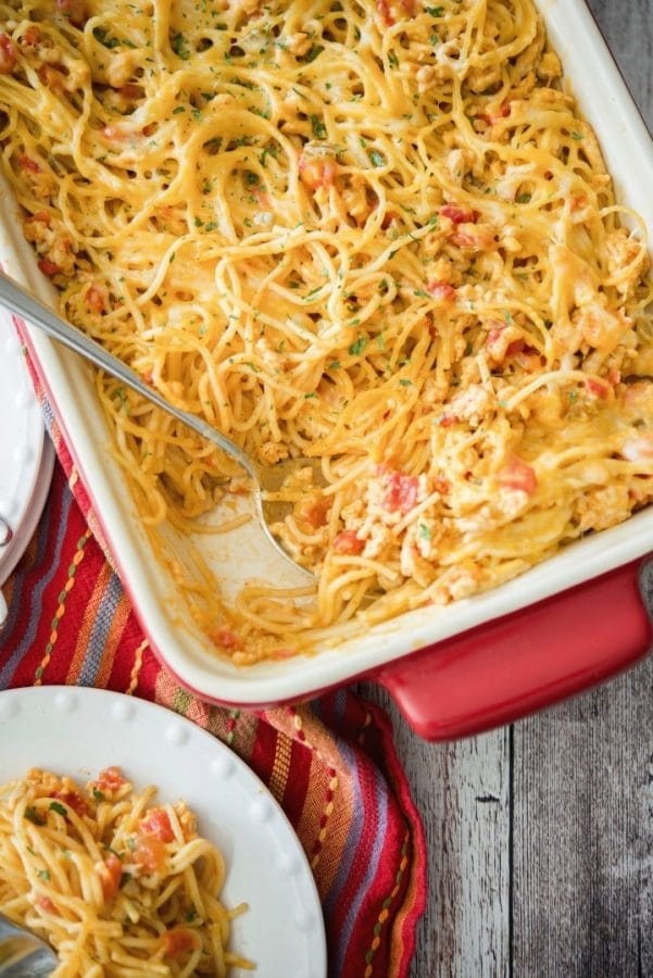 Low Fat Taco Spaghetti Casserole with a spoon in a casserole dish. 