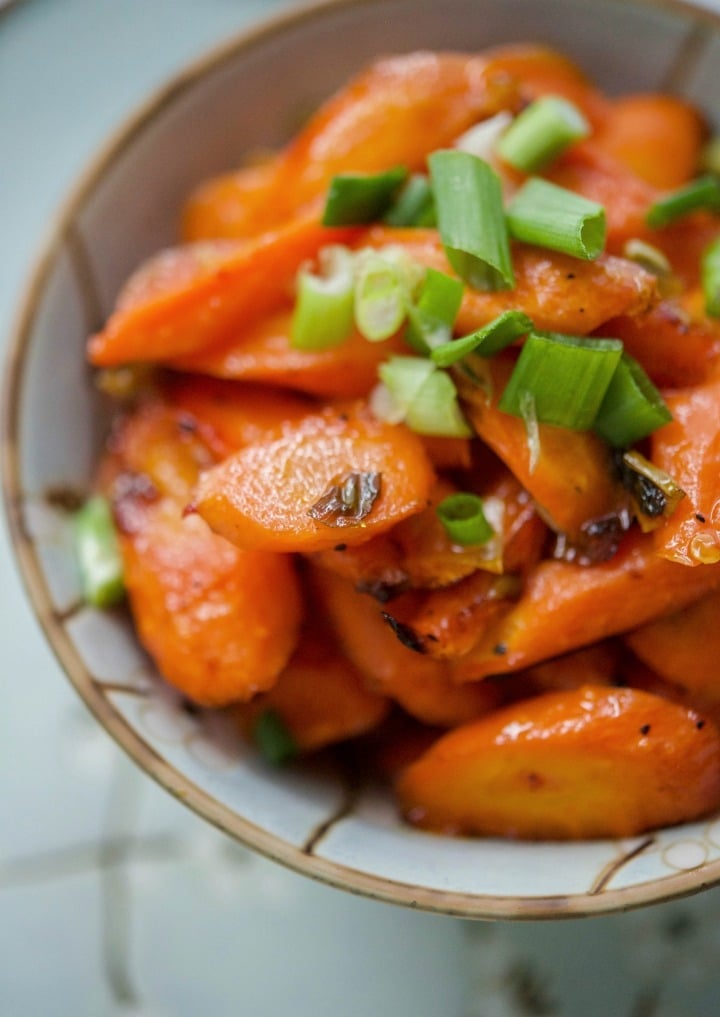 Sweet & Sour Roasted Carrots tossed in a mixture of sesame oil, garlic, chili paste, vinegar, salt and honey; then roasted until tender make the perfect side dish to any Asian inspired meal.