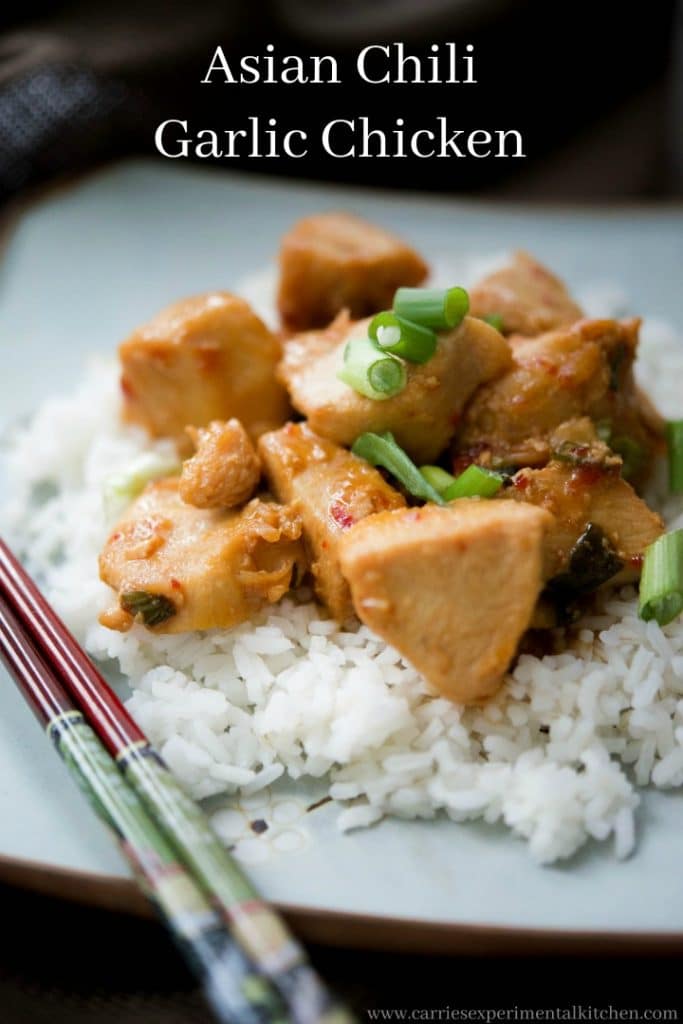 Asian Chili Garlic Chicken over rice on a plate with chopsticks.