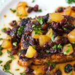 Boneless center cut pork loin chops dredged in cajun seasonings; then pan seared and topped with a honey, apple and raisin chutney.