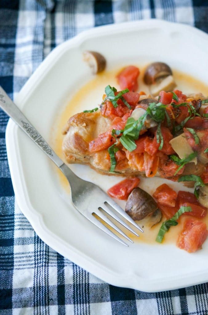 Braised boneless center cut pork chops with fire roasted tomatoes and Portobello mushrooms in a light cream sauce is deliciously light and flavorful.