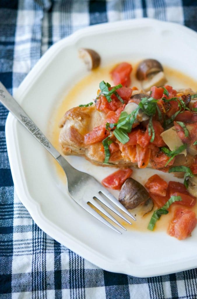 Braised boneless center cut pork chops with fire roasted tomatoes and Portobello mushrooms in a light cream sauce is deliciously light and flavorful.