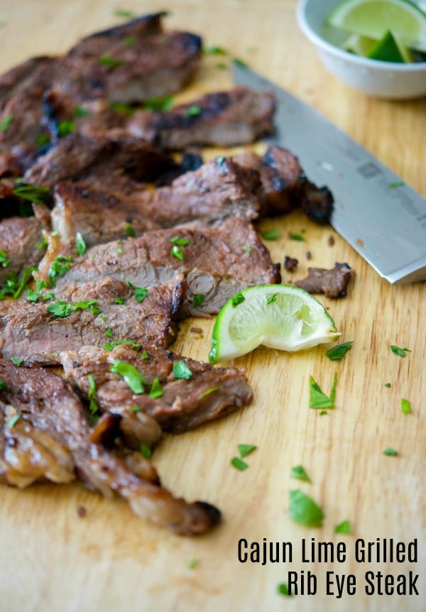 cajun lime grilled rib eye steak on a cutting board