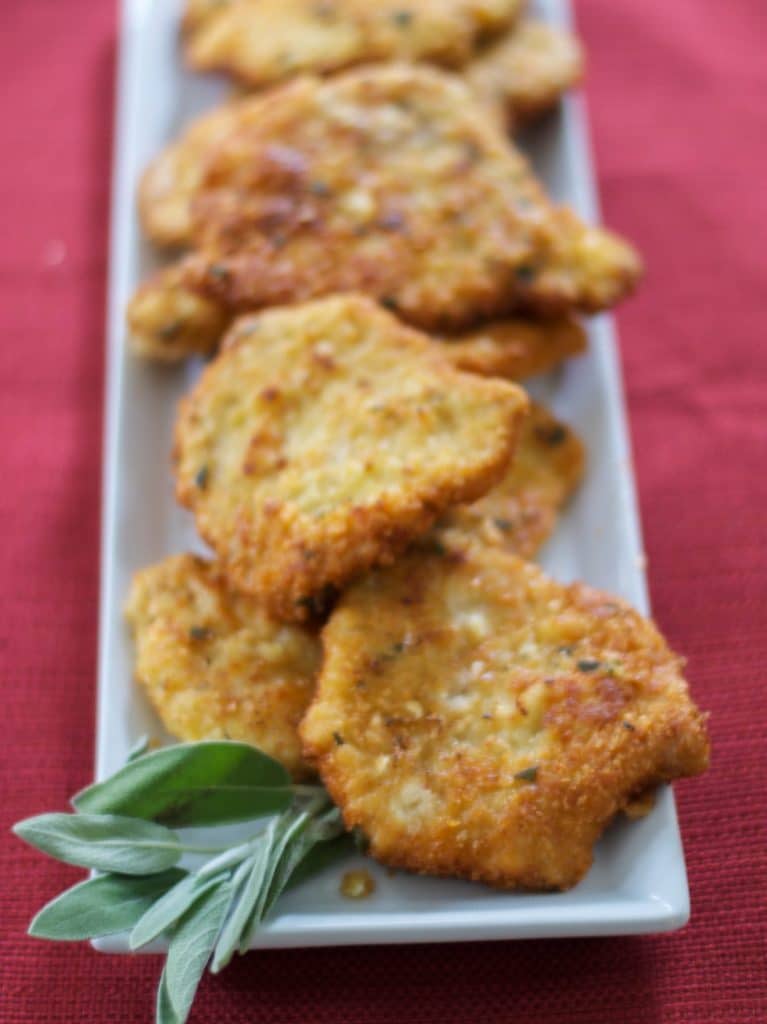 A plate of mustard & sage potato encrusted pork cutlets