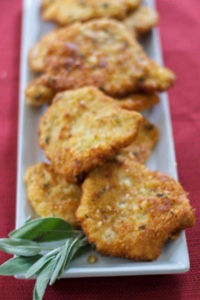 A plate of mustard & sage potato encrusted pork cutlets