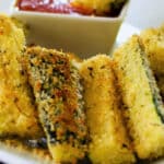 a close up of baked zucchini wedges on a plate