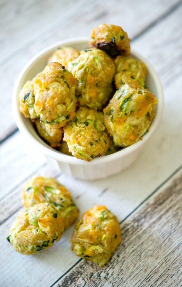 Baked Zucchini Tots made with garden fresh shredded zucchini, reduced fat shredded cheddar cheese and scallions are a healthier side dish option.