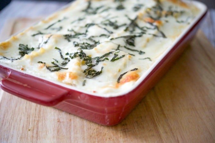 roasted vegetable ratatouille lasagna in red casserole dish