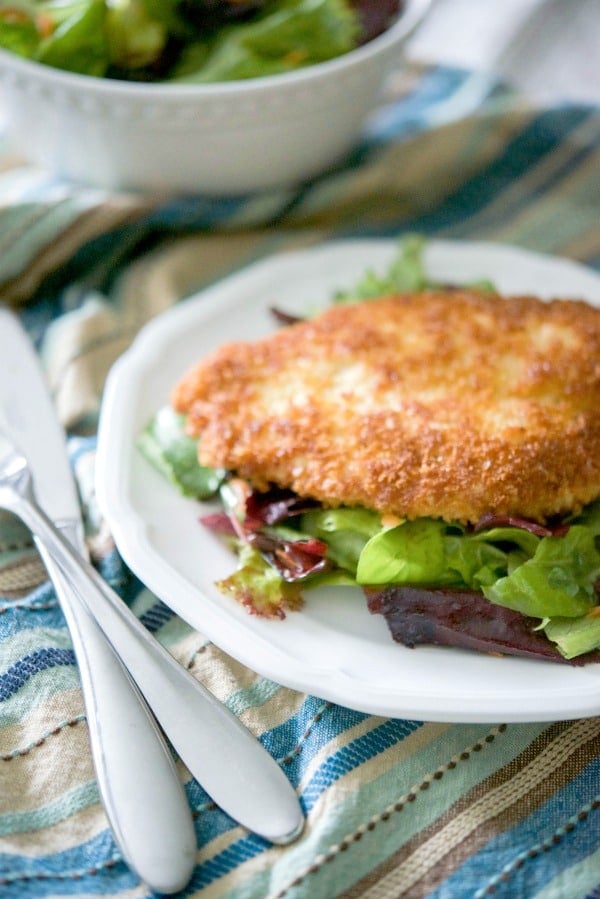 A plate of chicken a la diable with a fork