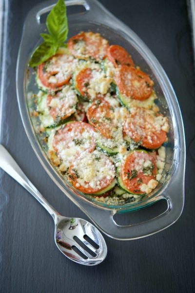 A dish of tomato and zucchini gratin with a spoon