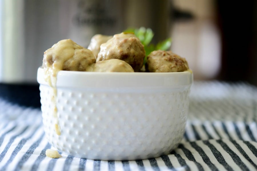 A close up of a bowl of steak diane meatballs