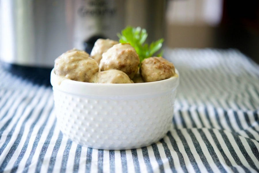 A bowl of steak diane meatballs on a table