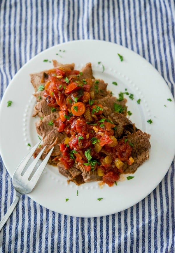 A plate of food on a table, with Brisket and Beef