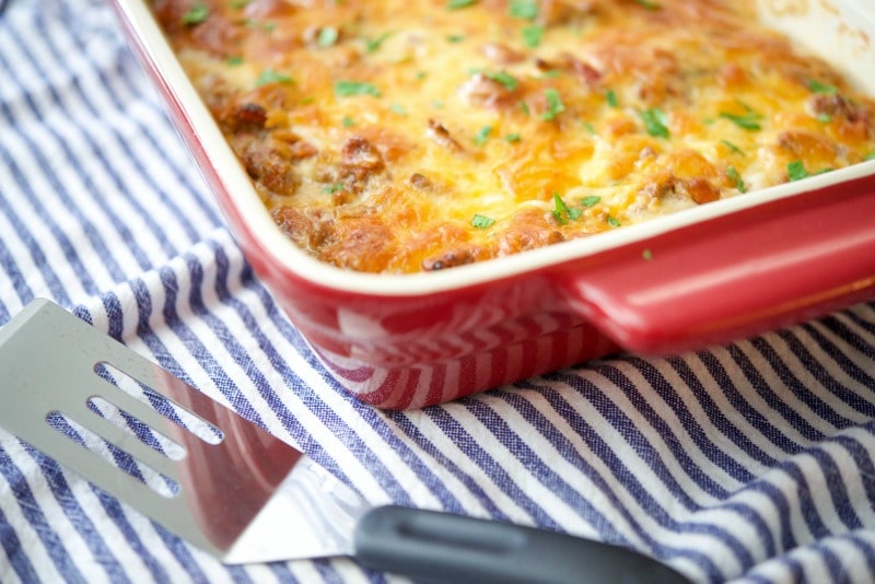Moussaka in a red casserole dish. 