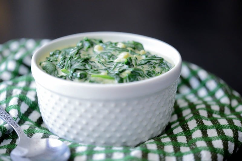 A bowl of food on a table, with Spinach and Cream