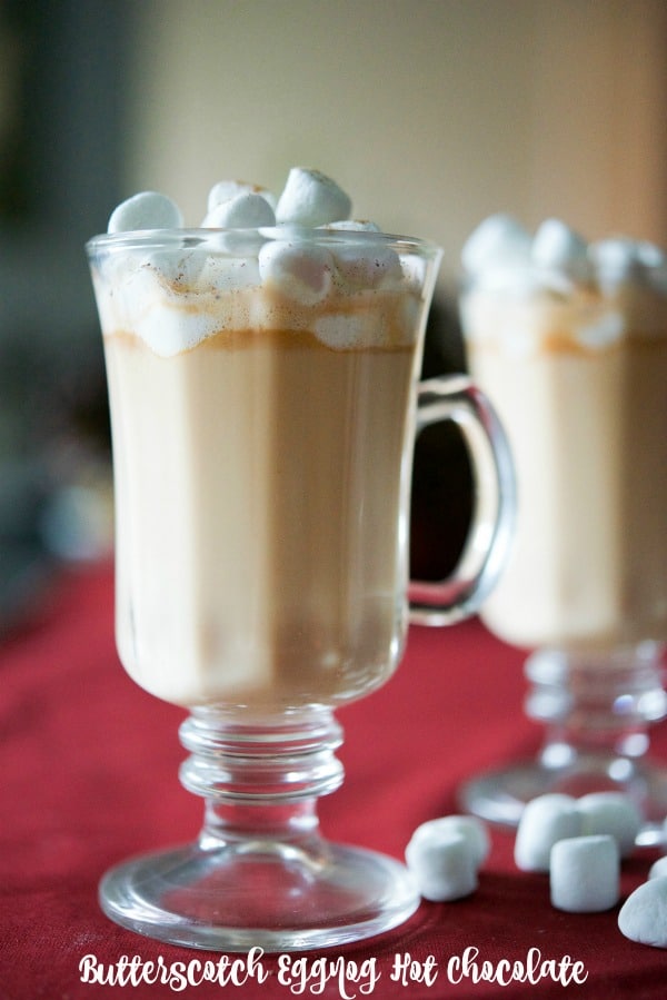 Butterscotch Eggnog Hot Chocolate in a clear glass mug close up.