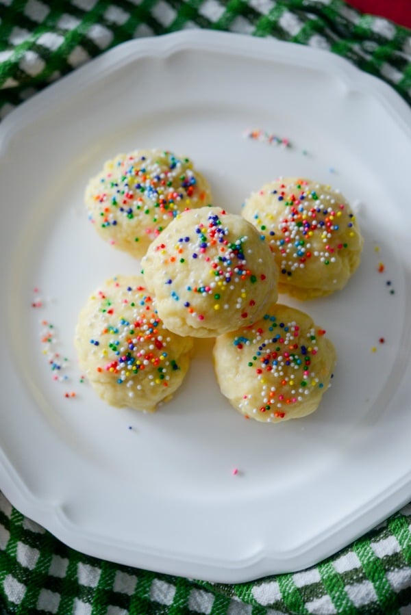 Italian Anise Cookies with sprinkles on a white plate. 