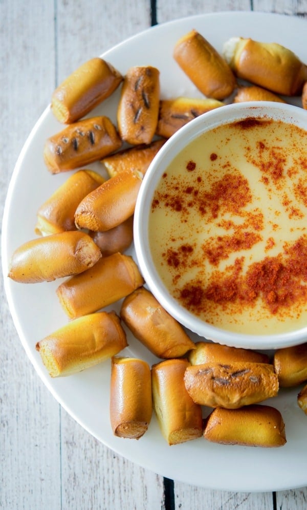 A plate of pretzel nibs with beer cheese dip. 