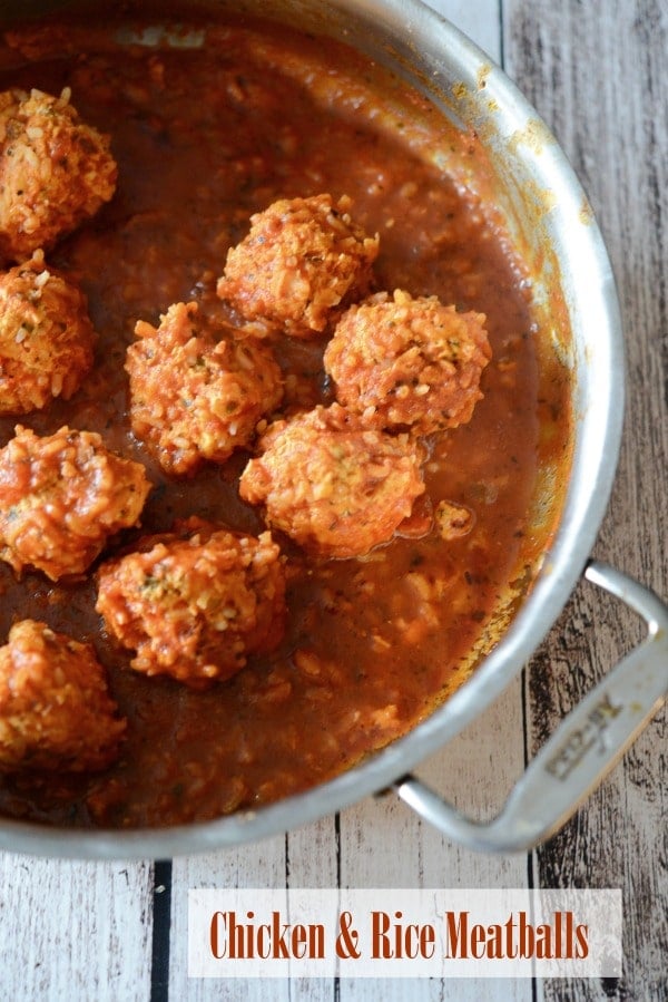 Chicken & Rice Meatballs made with ground chicken, fresh herbs and long grain rice cooked in a tomato sauce is a healthy dinner alternative with robust flavor.