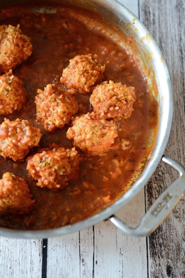 Chicken & Rice Meatballs made with ground chicken, fresh herbs and long grain rice cooked in a tomato sauce is a healthy dinner alternative with robust flavor. #chicken #rice #meatballs 