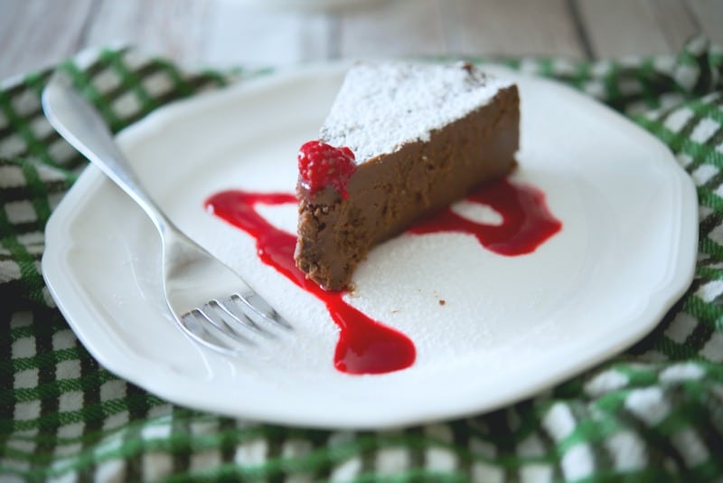 A piece of cake on a plate, with Chocolate and Cherry fudge