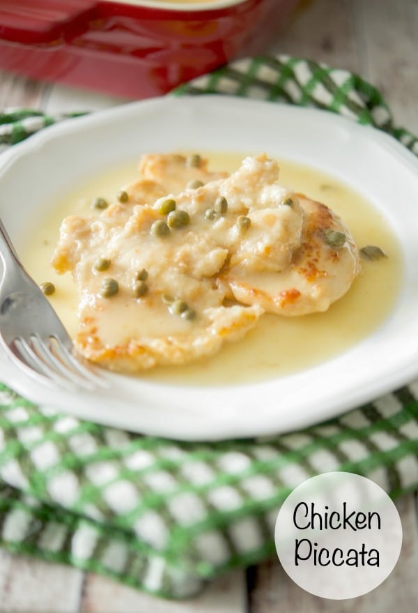 Chicken Piccata in a white plate with a fork.